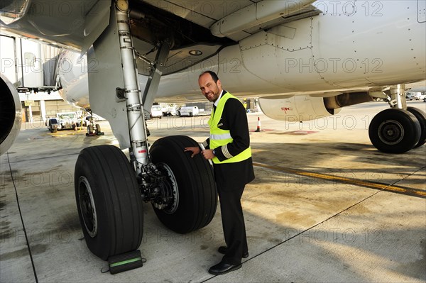 Pilot checking tyres and undercarriage