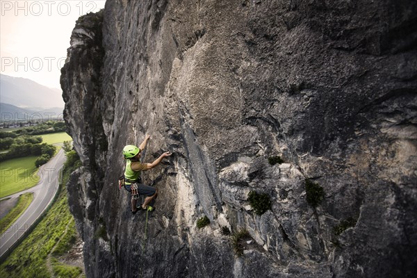 Climber lead climbing on a rock face