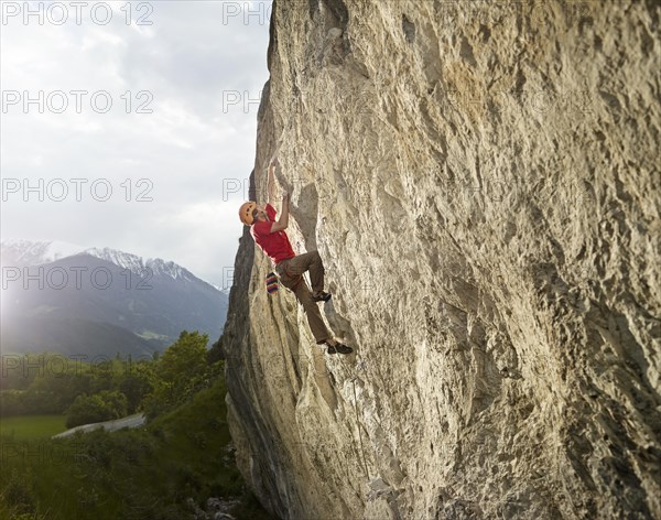 Climber lead climbing on a rock face