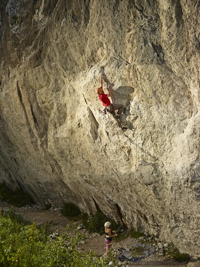 Climber lead climbing on a rock face