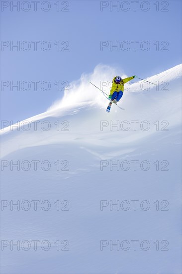 Freerider jumping off snow cornice