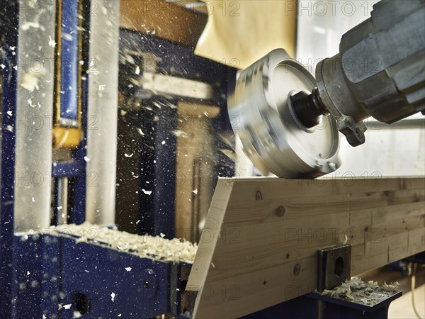 Wood milling machine shaping a wooden board