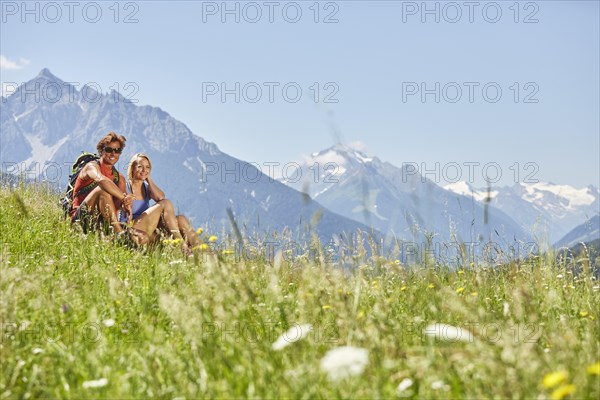 Man and woman sitting in a meadow