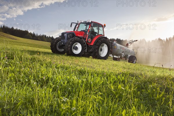 Manure spreader fertilizing a field