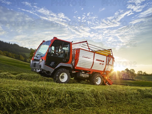 Unitrac transporter with forage trailer collecting the dried grass