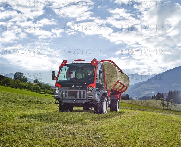 Unitrac transporter with forage trailer and a hay bale