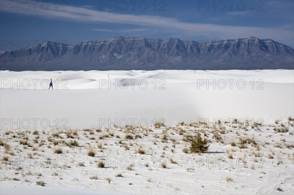 A woman hiking in White Sands National Monument