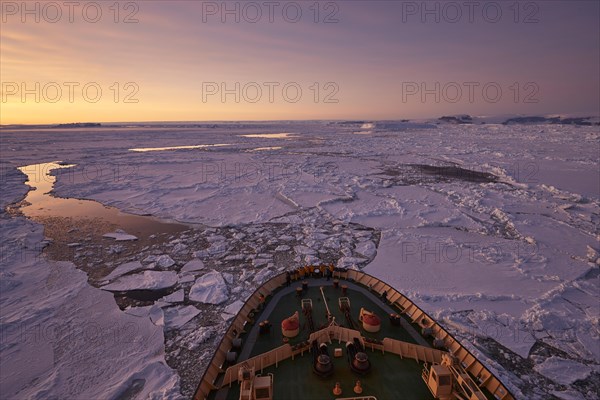 Bow of the icebreaker Kapitan Khlebnikov in the sea ice at afterglow