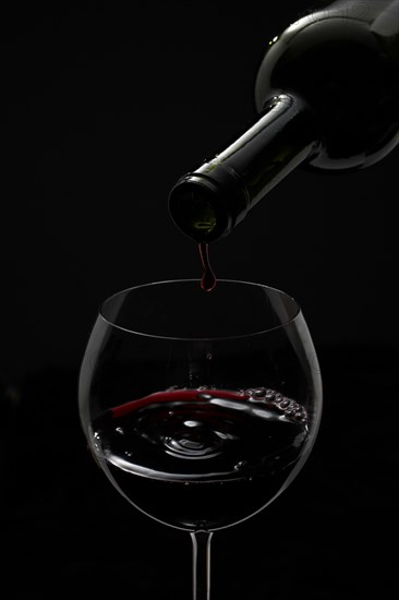 Red wine being poured into a glass