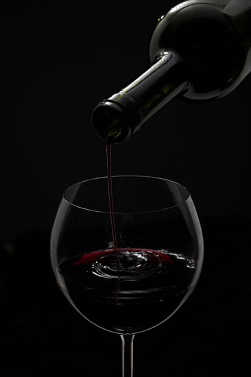 Red wine being poured into a glass