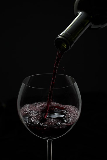 Red wine being poured into a glass