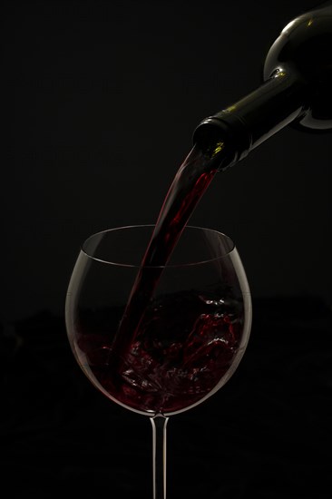 Red wine being poured into a glass