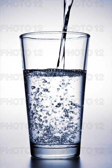 Water is being poured into a glass