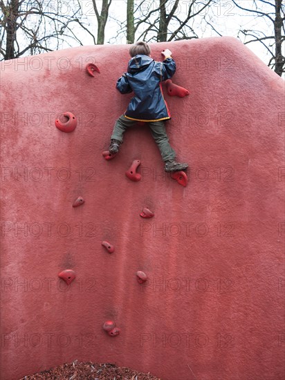 Child climbing on a climbing wall