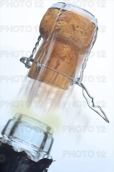 Champagne cork popping out of a champagne bottle