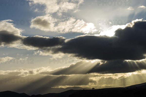 Sun rays breaking through the clouds in the evening light