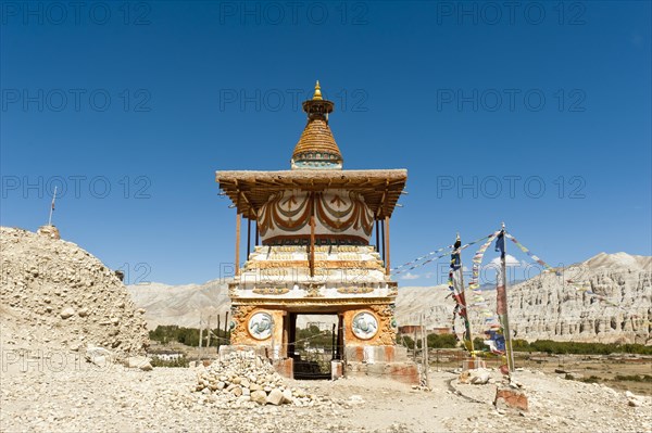 Colorful ornate Buddhist stupa at the entrance to the village
