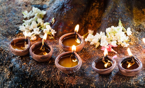 Burning candles in clay pots