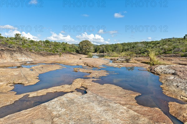 Tropical dry forest landscape with river and rocks