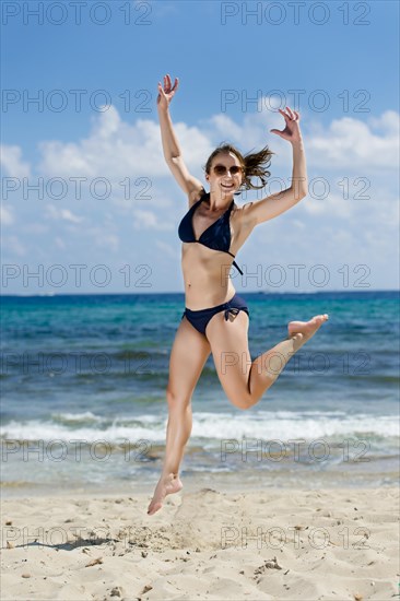 Woman jumping on the beach