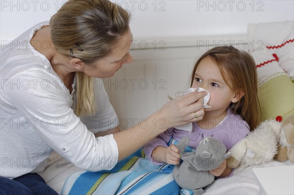 Mother taking care of her sick daughter