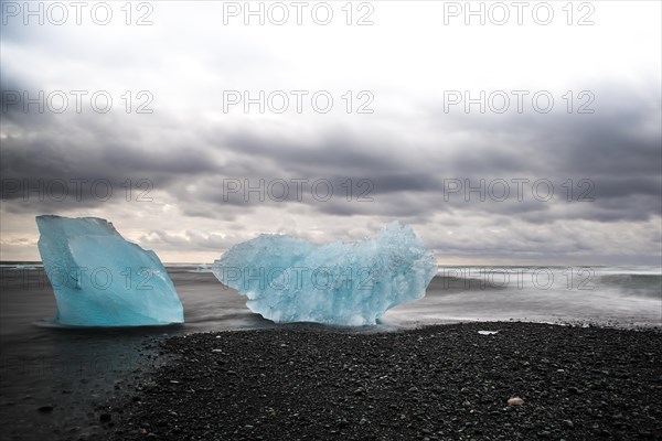 Ice floes on the black lava beach of the Jokulsarlon glacial lake