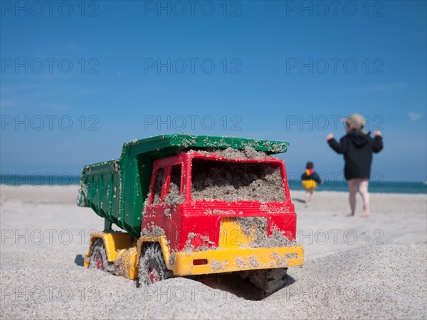 Toy dumper truck on a beach