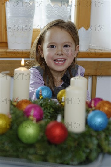 Girl enjoying the first lit candle on the Advent wreath