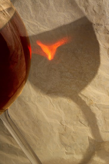 Red wine glass with reflection on tissue paper