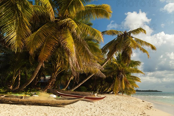 Palm beach with fishing boats and fishing nets