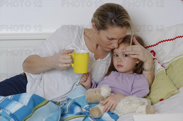 Mother taking care of her sick daughter