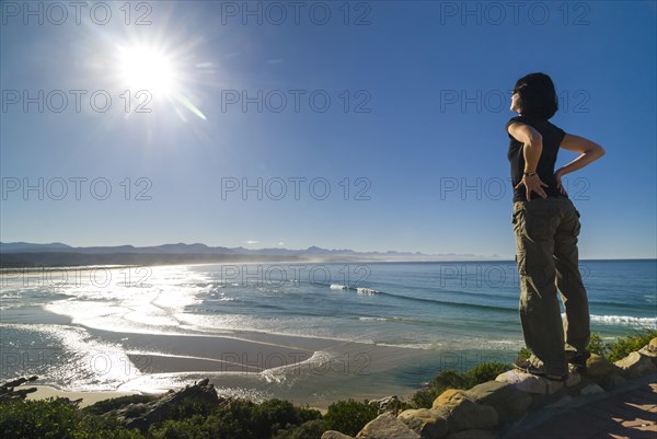Young woman looking at a bay and the Indian Ocean