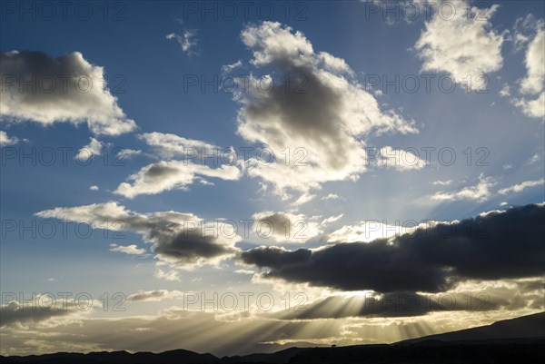 Sun rays breaking through the clouds in the evening light