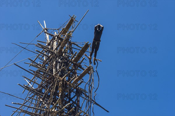 Man jumping from a bamboo tower