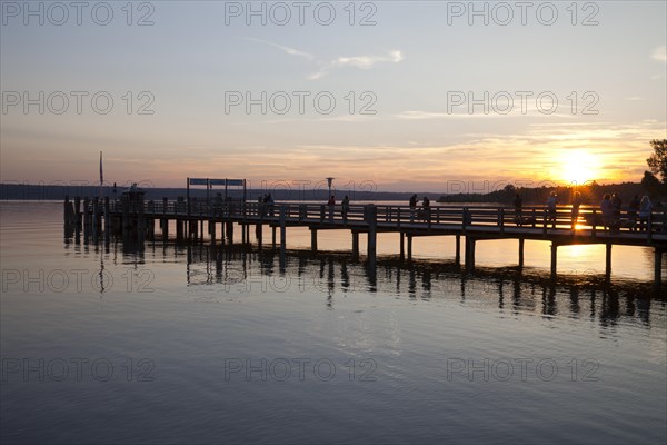 Jetty on Ammersee Lake or Lake Ammer in the evening light