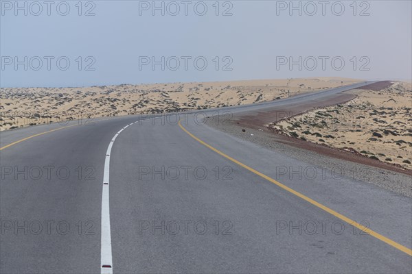 Omani highway through the sand desert
