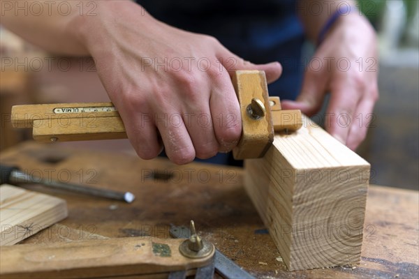 Joiner measuring wood