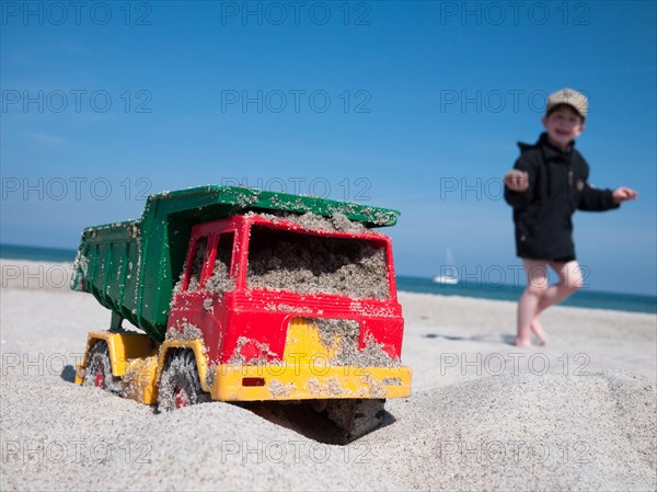 Toy dumper truck on a beach