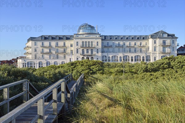 Wooden footbridge to the beach hotel behind the dunes