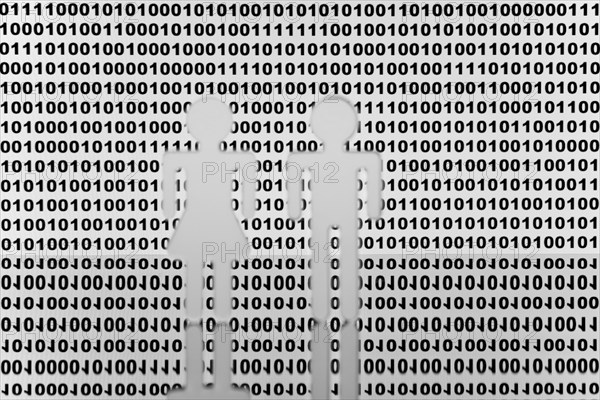 Two figures in front of binary code