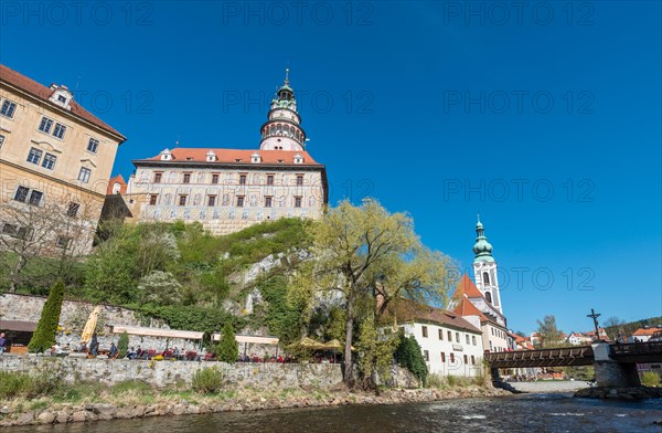 Cesky Krumlov Castle with its tower and the Church of St. Jost on the Vltava river