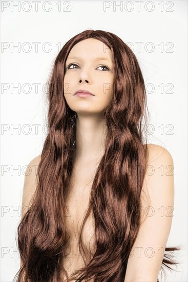 Topless woman wearing a wig with long hair