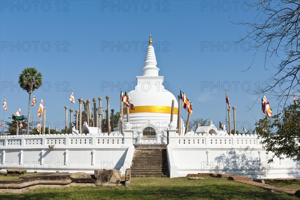 Old white stupa with orange ribbon