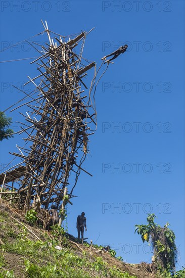 Man jumping from a bamboo tower