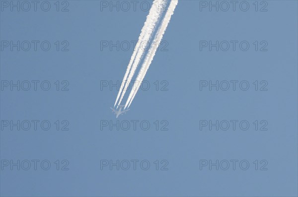 Contrails left by a four-engine airliner