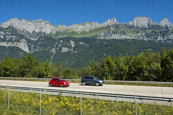 Vehicles on the A3 motorway in front of the Churfirsten range near Lake Walen