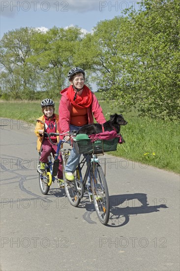 Mother and son with their dog on a cycling tour