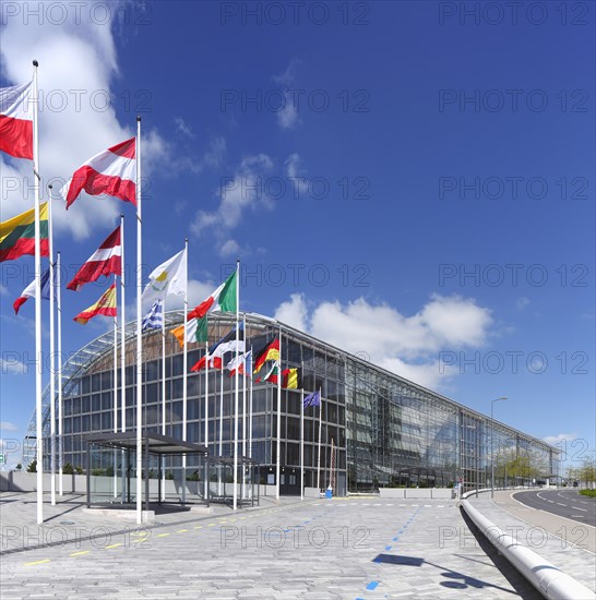 International flags waving in front of European Investment Bank
