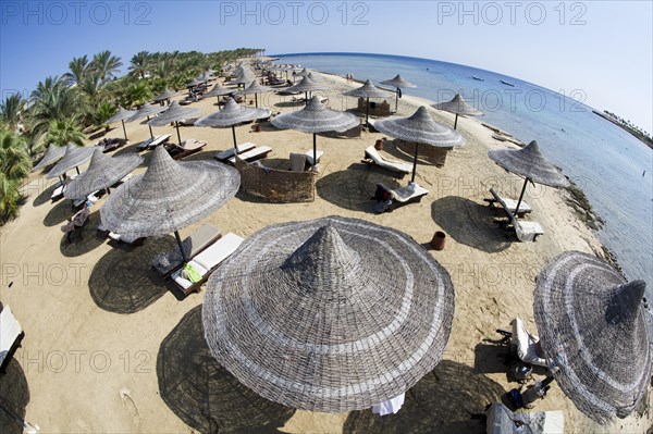 Sun umbrellas on a beach of Marsa Alam