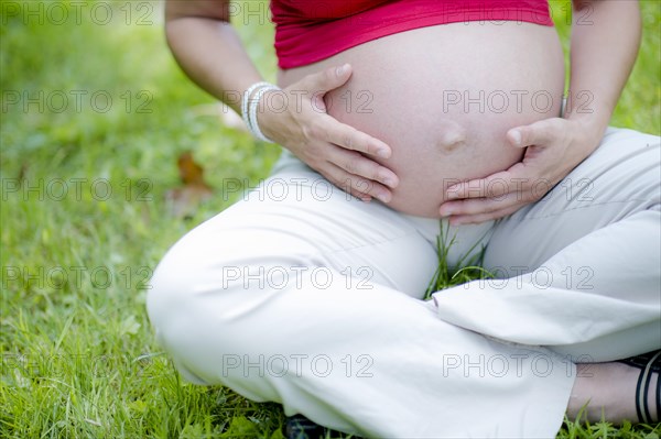 Pregnant woman touching her baby belly